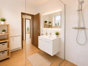 a bathroom with a white sink and a shower at Dill Apartments Pleinfeld Pacellistraße in Pleinfeld