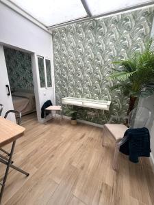 a living room with a bench on a wall at Teror Centro 1 in Teror +19 photos