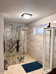a bathroom with a tree mural on the wall at Penzión Lili in Opatovce nad Nitrou +38 photos