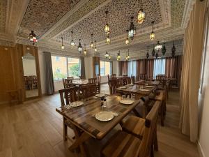 a large dining room with wooden tables and chairs at Hotel New Mars Dades in Aït Idaïr