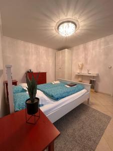 a bedroom with a large bed with a potted plant on it at Penzión Lili in Opatovce nad Nitrou