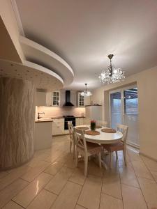 a kitchen and dining room with a table and chairs at Penzión Lili in Opatovce nad Nitrou
