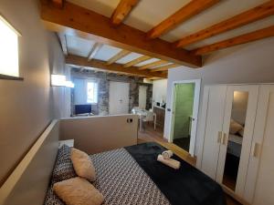 a bedroom with a bed in a room with wooden ceilings at Muelle Real in Mugardos