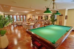 a pool table in a room with tables and chairs at Hotel Almirante Cartagena Colombia in Cartagena de Indias