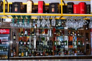 a bar with a lot of bottles of alcohol at Nkandla Lifestyle in Mthatha