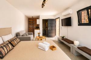 a living room with a large bed and a couch at Villa Melisea in Sfendoúrion +26 photos