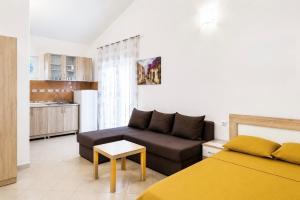 a living room with a bed and a couch at Apartments Sofia in Sutomore