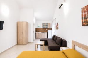 a living room with a couch and a kitchen at Apartments Sofia in Sutomore