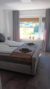a bedroom with two beds and a large window at Kontinental A in Bad Harzburg
