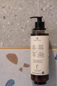a bottle of tika moisturizing lotion sitting on a table at Hotel Evo in Witunia +24 photos