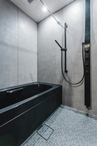 a bathroom with a bath tub and a shower at SLL Urban Suites Ebisu in Tokyo +105 photos