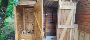 a wooden out house with a toilet in it at Roulotte de Combeplane in Carnac-Rouffiac