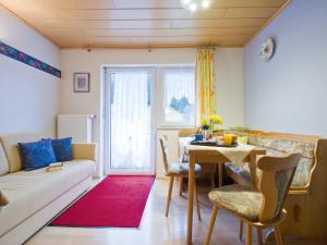 a living room with a couch and a table at Landpension Am Sommerhang in Bad Rippoldsau