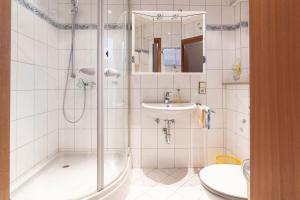 a bathroom with a shower and a sink at Landpension Am Sommerhang in Bad Rippoldsau +107 photos