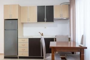 a kitchen with a table and a refrigerator at Cloud Nine Retreat, Ksamil in Ksamil