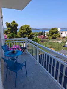 a balcony with a table and chairs and the ocean at Apartments Mare in Hvar