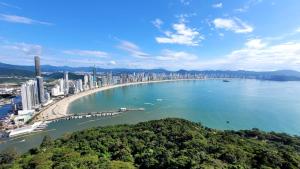 an aerial view of a city with a beach and buildings at Hotel Melo in Balneário Camboriú +21 photos