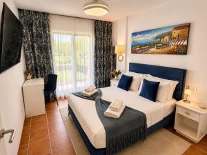a bedroom with a large bed with blue pillows at Casa de Andres Mojácar in Mojácar +49 photos
