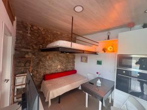 a small room with a bed and a table at Alojamiento Colinas in Monachil