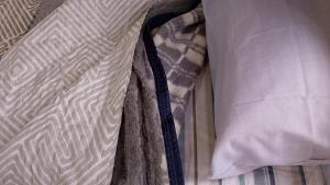 a close up of a bed with a pillow at "ATARDECER" Departamento a pocos minutos de termas in Chajarí