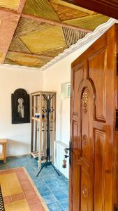 a room with a wooden ceiling and a wooden door at Hotel New Mars Dades in Aït Idaïr