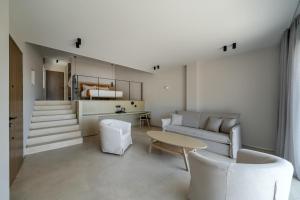 a living room with a couch and a table at KHAI Syvota in Syvota
