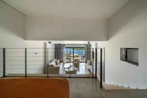 a bedroom with a bed and a living room at KHAI Syvota in Syvota +18 photos