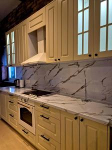 a kitchen with white marble counter tops and white cabinets at Ahar in Sarajevo
