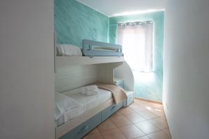 a small room with a bunk bed and a window at Teresan Homestay in Mascali +43 photos