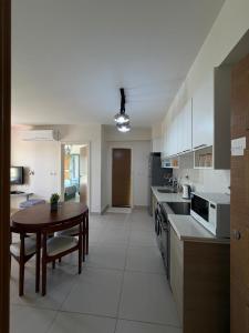a large kitchen with a table and a table and a dining room at Chalet in the marassi marina 2 in El Alamein