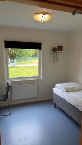 a bedroom with a bed and a large window at Örkelljunga Hostel in Orkelljunga