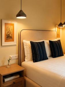a bedroom with a bed with black and white pillows at Hotel "Villa Niche" By Bratheim in Tirana