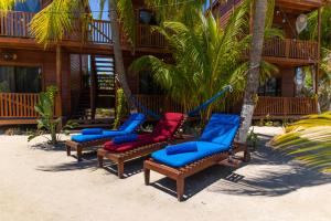 a group of lounge chairs on the beach at Coconut by ÓOL Hotels in Holbox Island