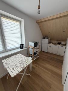 a kitchen with a table and a chair in a room at Wiatrakówka in Kosewo +36 photos