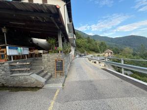 a building with a sign on the side of a road at La Pergola in Auressio