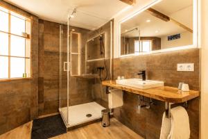 a bathroom with a sink and a shower at Harzlodge Lebenstraum in Braunlage +23 photos