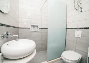a white bathroom with a sink and a toilet at Villa Antonio in Ulcinj +44 photos