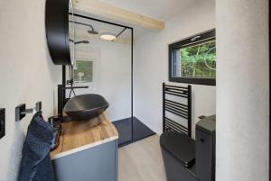 a bathroom with a sink and a mirror at Forest&Lake Retreat in Dehtáře