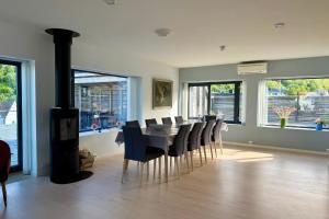 a dining room with a fireplace and a table and chairs at LofotenApartmentOne in Stamsund