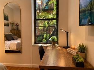 a room with a table and a window with a bed at Union Nest in New York