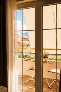 a view of a balcony from a room with sliding glass doors at Hotel "Villa Niche" By Bratheim in Tirana