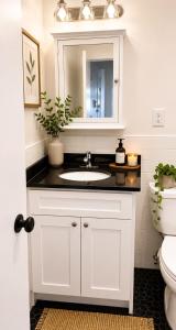 a white bathroom with a sink and a toilet at Union Nest in New York +3 photos