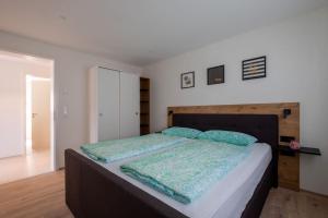 a bedroom with a large bed with a wooden headboard at Domizil Relax - Fewo Seeluft in ruhiger zentraler Lage in Überlingen