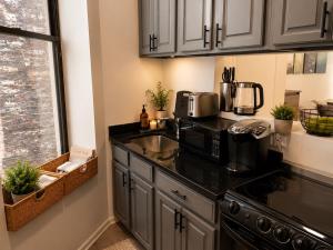 a kitchen with a sink and a microwave at Union Nest in New York