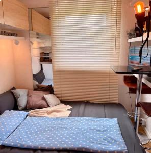 a bedroom with a bed and a large window at Mini Apartment in Öhningen
