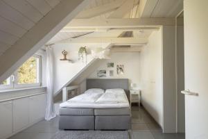 a bedroom with a bed in a attic at Ferienwohnung Blaupause Reichenau mit Seezugang und Wiese zum Entspannen in Reichenau +17 photos