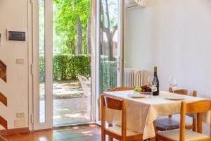 a dining room with a table and a glass door at Borgo San Giorgio by La Principina in Grosseto