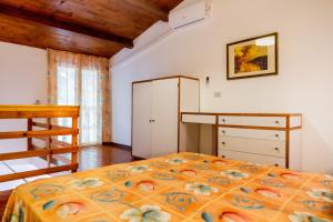 a bedroom with a bed and a dresser at Borgo San Giorgio by La Principina in Grosseto +81 photos