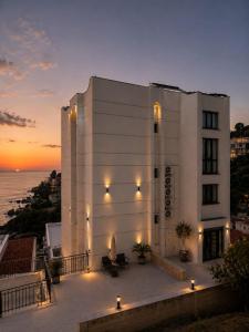 a white building with a sunset in the background at Rajna Apartments in Ulcinj