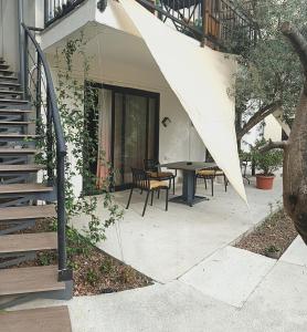 a patio with a table and an umbrella at Apartments Spasoje 2 in Kotor